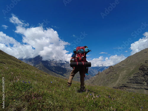 Himachal, India - July 10th, 2022 : Man with trekking bag in the mountain, summer hike with backpacks, himalayan view