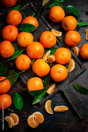 Fragrant fresh tangerines on a cutting board. 