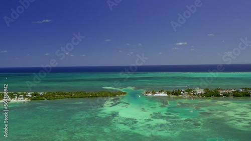 Drone shot over the split lagoon, revealing resorts and buildings, at the Caye Caulker island, Belize, Central America 