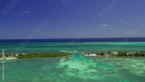 Drone shot over the split lagoon, revealing resorts and buildings, at the Caye Caulker island, Belize, Central America  photo