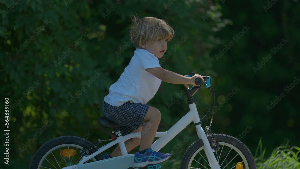 Sportive child riding bike at park one boy Sportive child riding bike at park one boy
