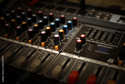 Sound mixer. Professional audio mixing console with lights, buttons, faders and sliders.