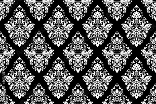 Wallpaper in the style of Baroque. Seamless vector background. White and black floral ornament. Graphic pattern for fabric, wallpaper, packaging. Ornate Damask flower ornament