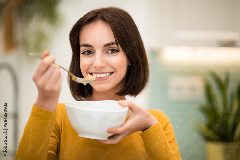 Portrait of pretty happy fit lady having oatmeal Portrait of pretty happy fit lady having oatmeal