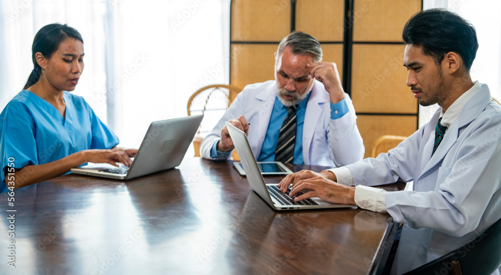 team of doctors and nurses with senior doctors teaching and thinking how to treat patients with young Asian nurses and interns at a meeting table in a hospital. team of doctors and nurses with senior doctors teaching and thinking how to treat patients with young Asian nurses and interns at a meeting table in a hospital.