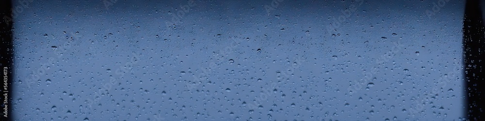 Raindrops on glass - panoramic photorealistic image with 3D shading created by generative AI for web banners Raindrops on glass - panoramic photorealistic image with 3D shading created by generative AI for web banners