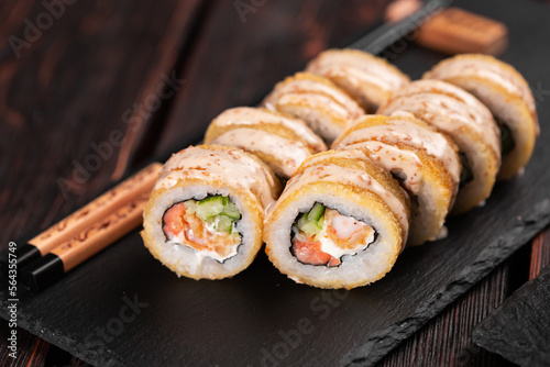 Roll with fish sushi with chopsticks - asian food concept