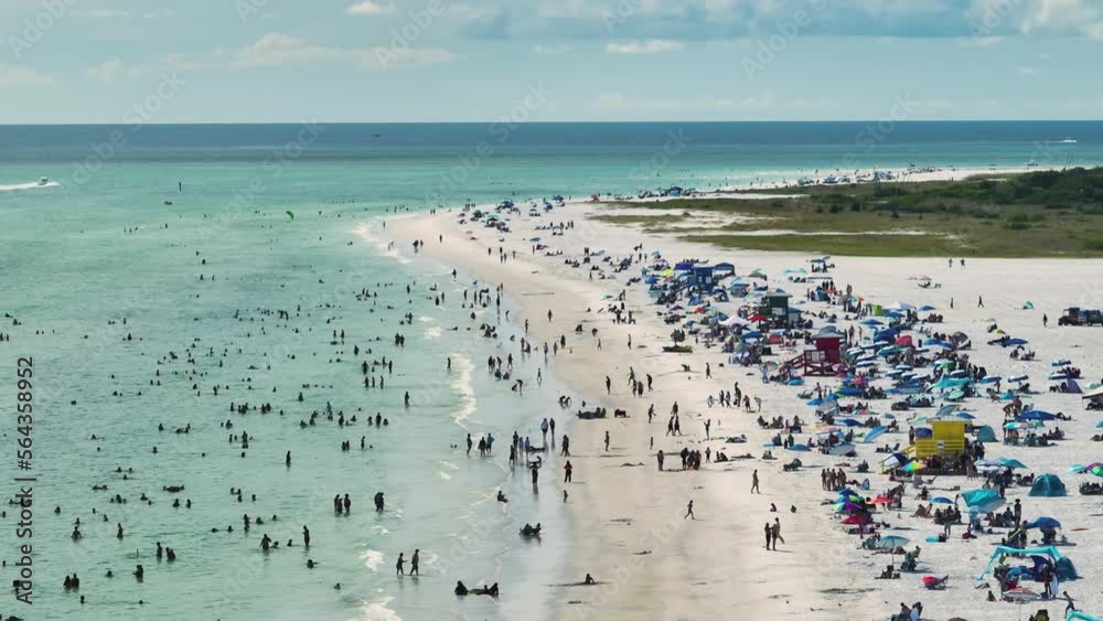 Aerial seascape with Siesta Key sandy beach in Sarasota, USA. Many tourists enjoing summer vacation time swimming in warm Mexico gulf water and sunbathing on hot Florida sun Aerial seascape with Siesta Key sandy beach in Sarasota, USA. Many tourists enjoing summer vacation time swimming in warm Mexico gulf water and sunbathing on hot Florida sun