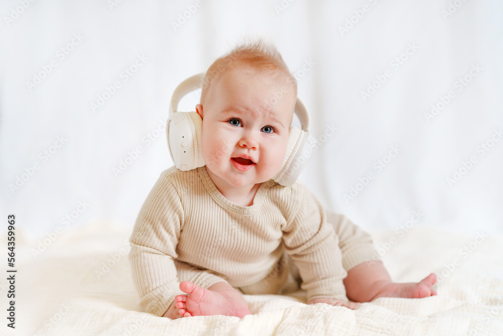 Baby in big headphones on a white background Baby in big headphones on a white background