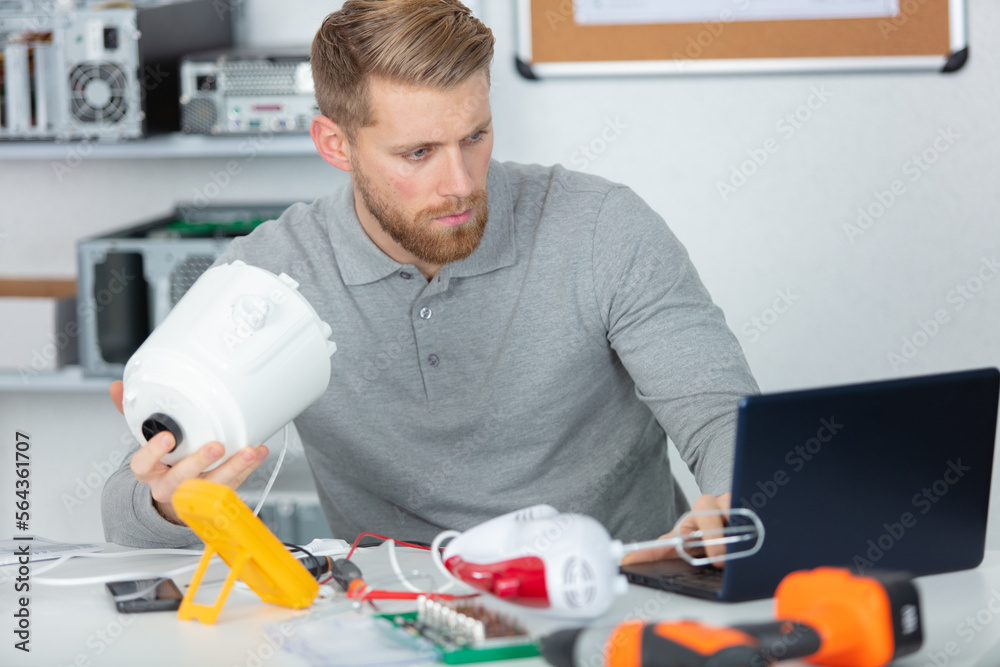 young man repairer in service center young man repairer in service center