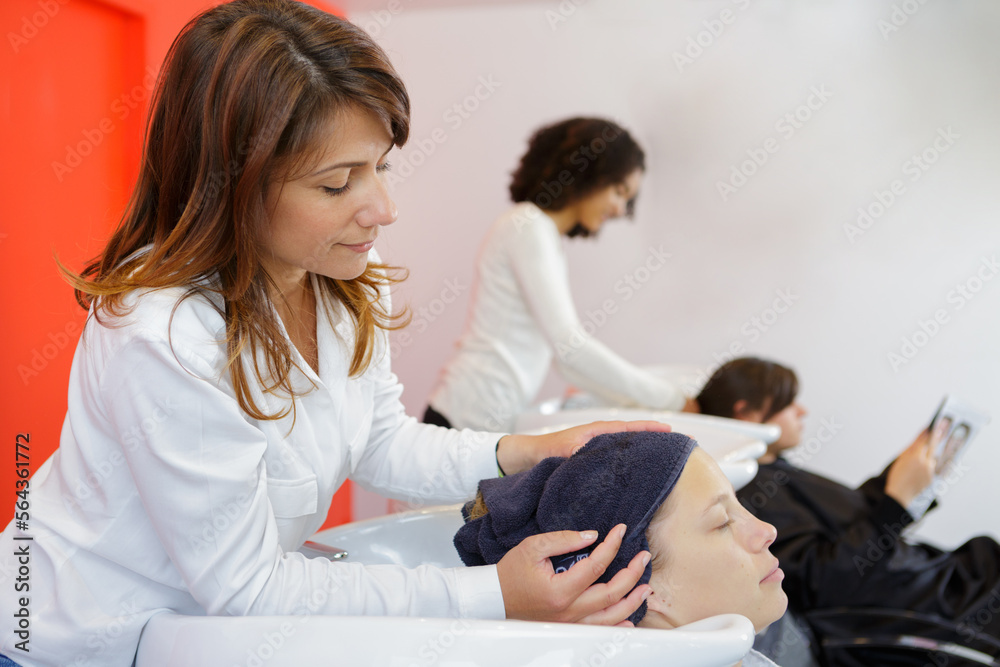 hairstylist drying the clients hair with towel hairstylist drying the clients hair with towel