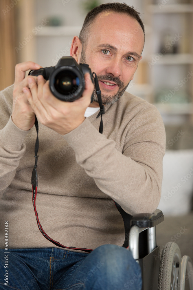 man in wheelchair training to become photographer man in wheelchair training to become photographer