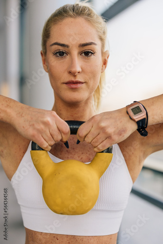 Portrait of a strong determent blonde young woman in the gym photo