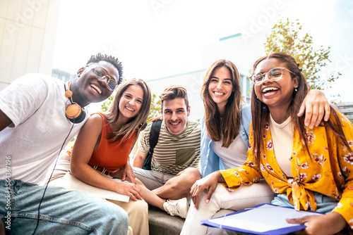 Canvastavla Low angle view of a happy group of multiracial friends looking at camera, enjoying outdoors