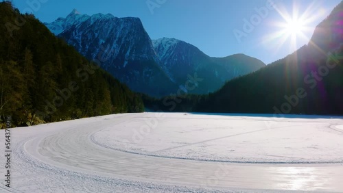 Flight over Lake Piburg in winter. Oetztal, Austria. photo