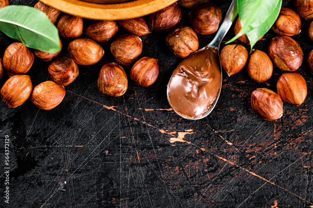 Fototapeta premium Hazelnut butter in a spoon on the table. 