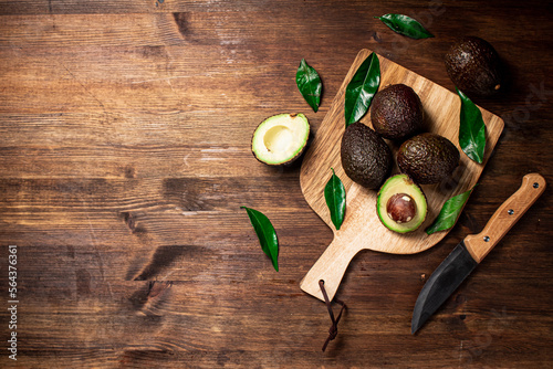 Halves of fresh avocado on a cutting board. 