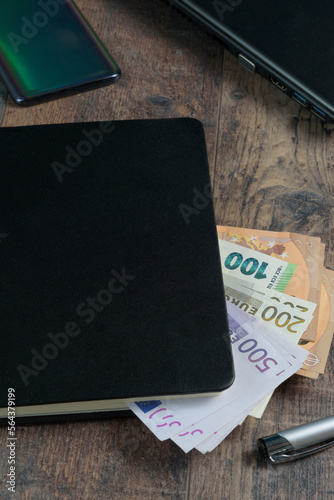 Принти на полотні Banknotes in Euros, account book, smartphone and pen on a wooden table