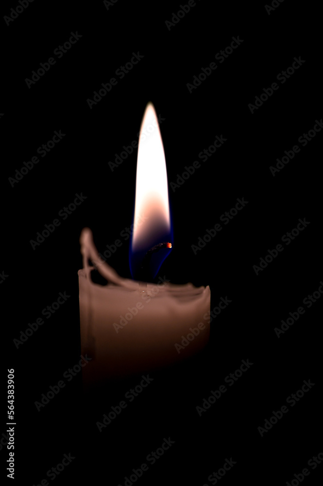 one burning candle in dark black room one burning candle in dark black room