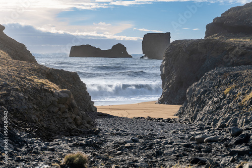 Dyrhólaey (Dyrholaey, Door Hill Island, Cape Portland), small promontory located on south coast of Iceland, near Vik. Kirkjufjara Beach views of sea stacks and rolling Atlantic Ocean waves. photo