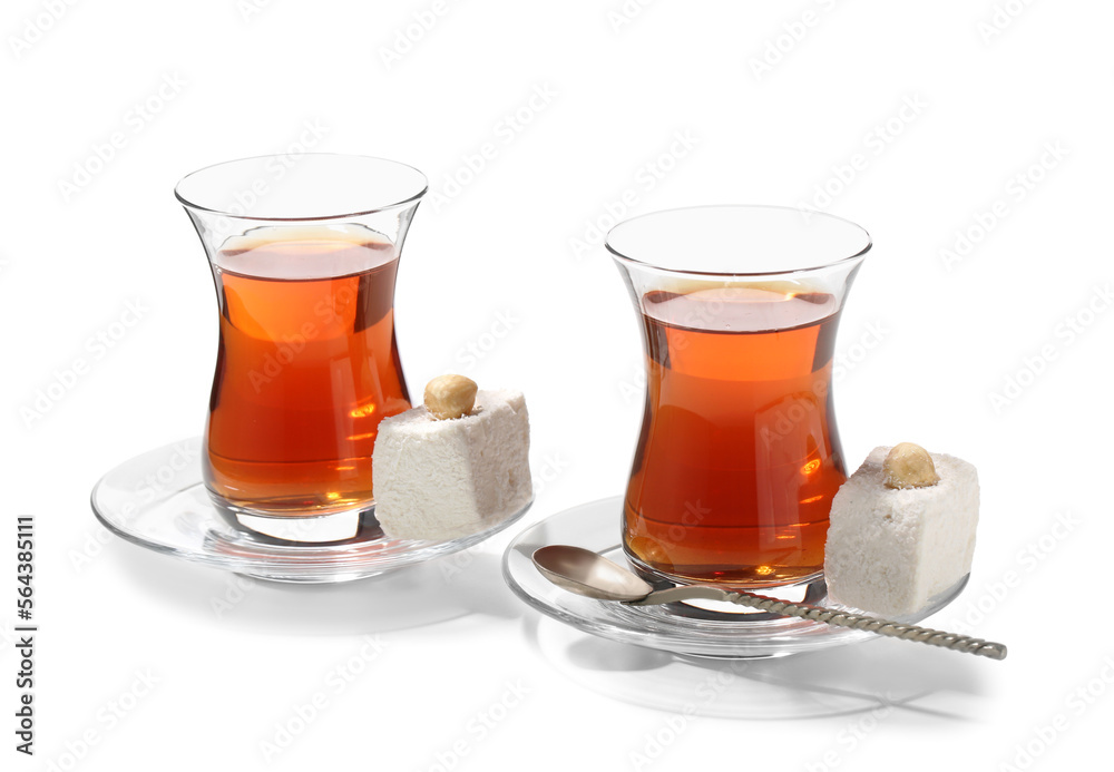 Glass cups of Turkish tea and sweets on white background Glass cups of Turkish tea and sweets on white background