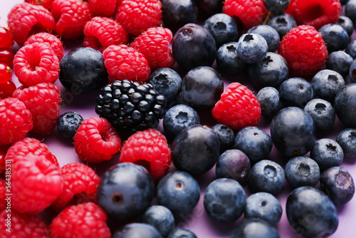 Heap of fresh ripe berries on color background  closeup