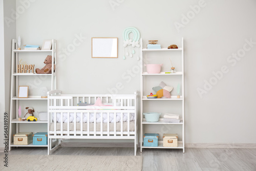 Stylish interior of children's room with baby bed