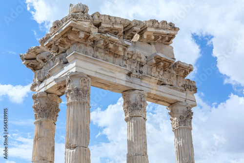 The Temple of Trajan in Pergamon Ancient City. Close up fragment of the entablature of the ruined temple with a stone-cut relief on the frieze. History, art or architecture concept. Bergama, Turkey