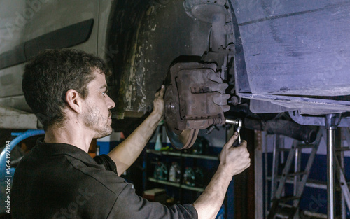 Repairman installing brake discs in workshop