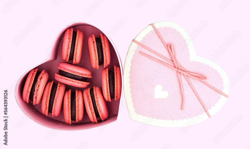 Heart shaped box with macarons on pink background. Symbol of love. Valentine's Day Heart shaped box with macarons on pink background. Symbol of love. Valentine's Day