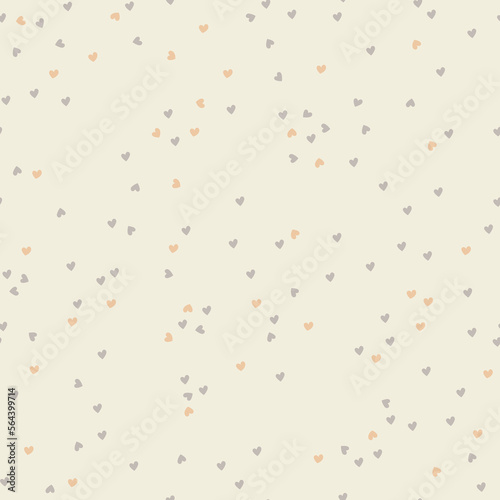 Small gray and golden hearts scattered around beige background. Seamless pattern design. Valentines Day
