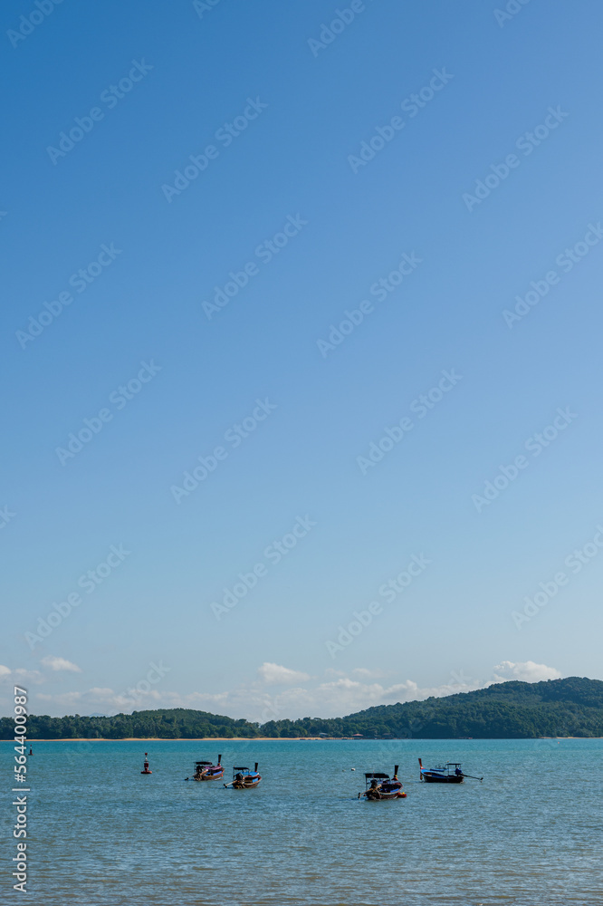 Group of long-tail boats in the sea. Tropical seascape from Thailand with copy space Group of long-tail boats in the sea. Tropical seascape from Thailand with copy space
