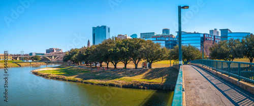 Fort Worth panoramic city skyline, buildings, and walking trails over the Trinity River Bridge, a cityscape with natural open space in Texas photo