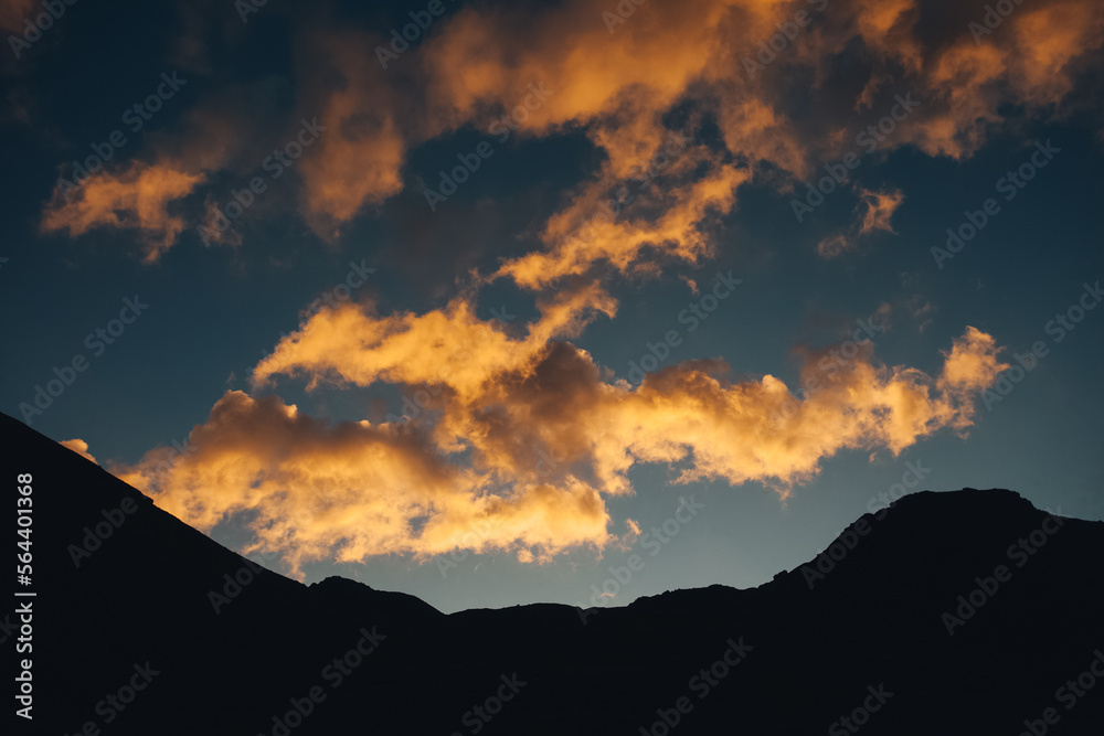Alpine panorama with mountain silhouettes and sunlit clouds at sunset, Vallelunga, Alto Adige Sudtirol, Italy