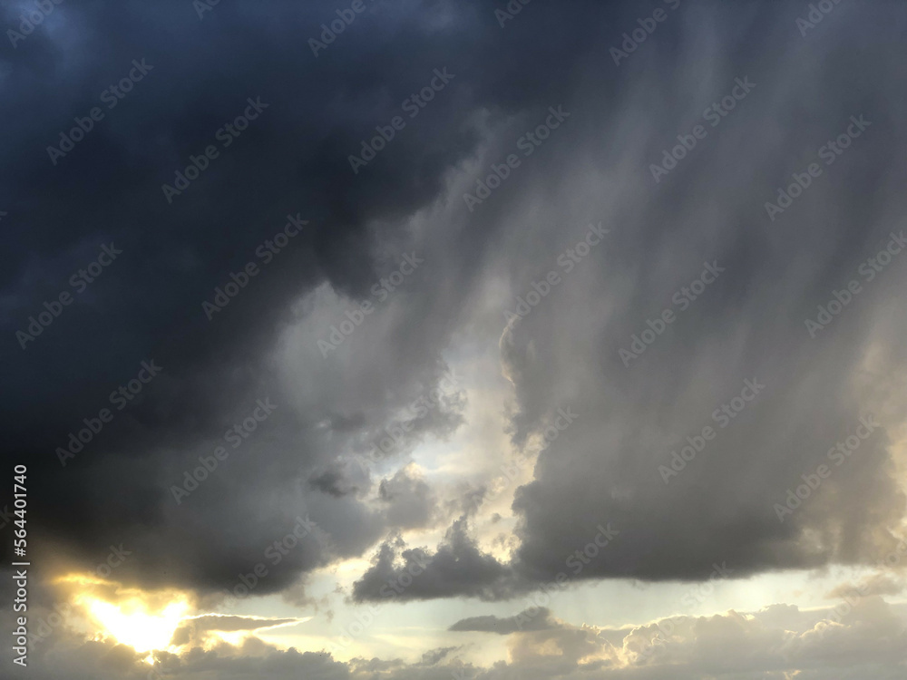 Black clouds at sunset and sun rays