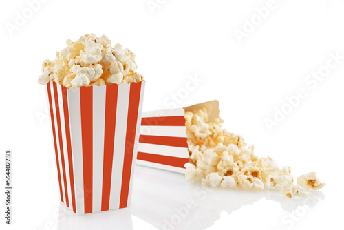 Two red white striped carton buckets with tasty cheese popcorn, isolated on white background. Box with scattering of popcorn grains. Movies, cinema and entertainment concept.