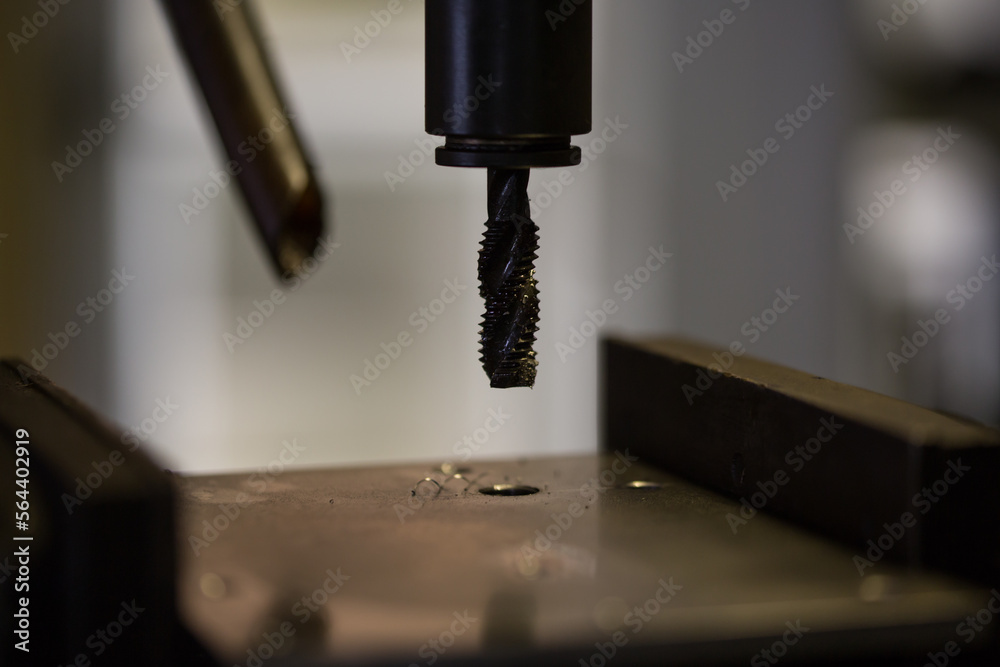 Thread cutting work with a tapping drilling machine