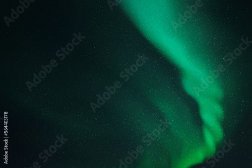 Green aurora borealis. Night starry sky and .Northern lights.