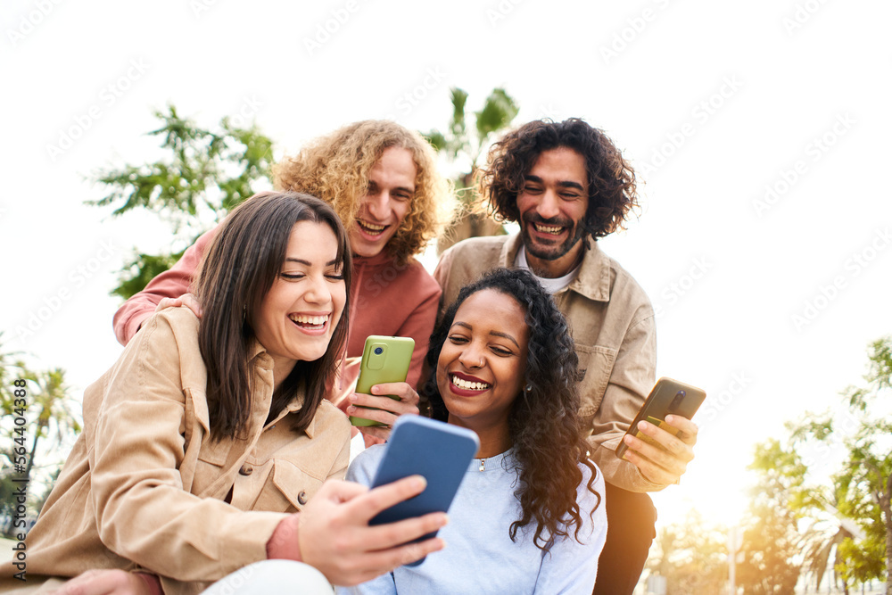 Happy friends using phones and laughing. People and technology having fun. High quality photo Happy friends using phones and laughing. People and technology having fun. High quality photo