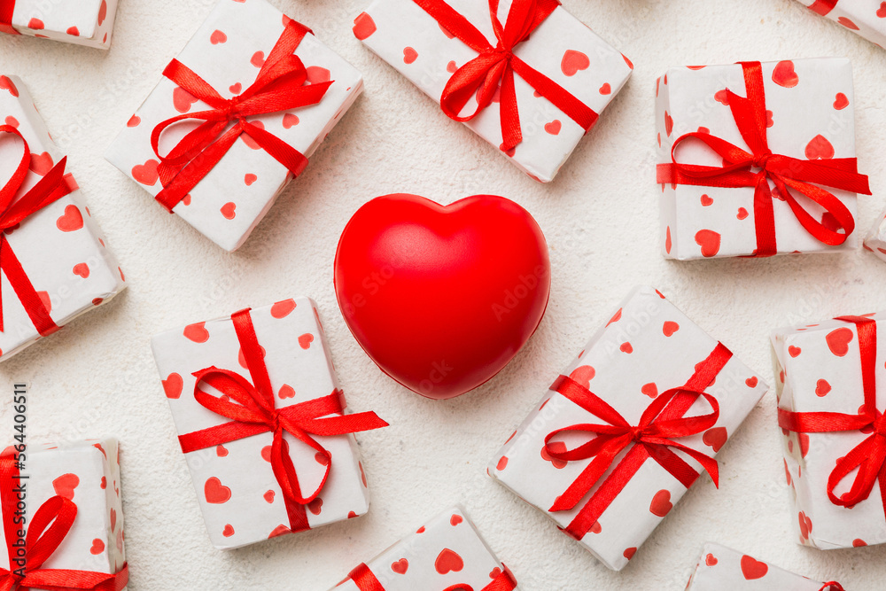 gift box with red bow and red heart on colored background . Top view. Flat lay gift box with red bow and red heart on colored background . Top view. Flat lay