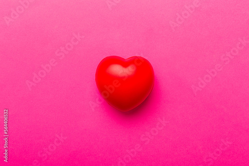 red heart shape on colored background. minimal concept top view with copy space