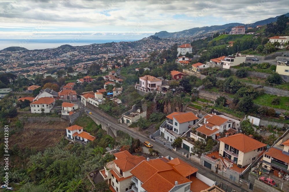View from a height on the slopes of the island of Madeira with houses.