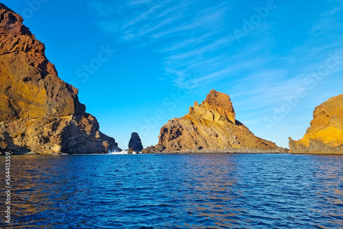 The rocks of an island in the Atlantic Ocean. Rocks stick out of the water.