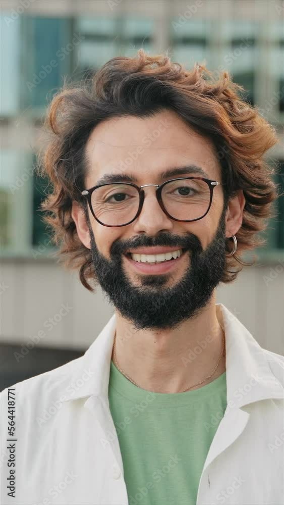 Happy Young Man with beard and eyeglasses Smiling to the camera - vertical video Happy Young Man with beard and eyeglasses Smiling to the camera - vertical video