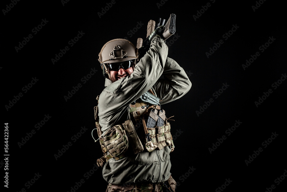 American special forces, a soldier in a military uniform with a weapon attacks on a black background, a ranger for special operations American special forces, a soldier in a military uniform with a weapon attacks on a black background, a ranger for special operations