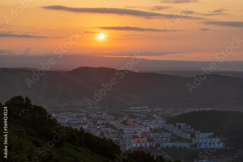 Morning cityscape. Top view of the buildings among the hills. Residential urban areas at sunrise. The sun rises over the mountains. City of Petropavlovsk-Kamchatsky  Kamchatka Krai  Far East of Russia