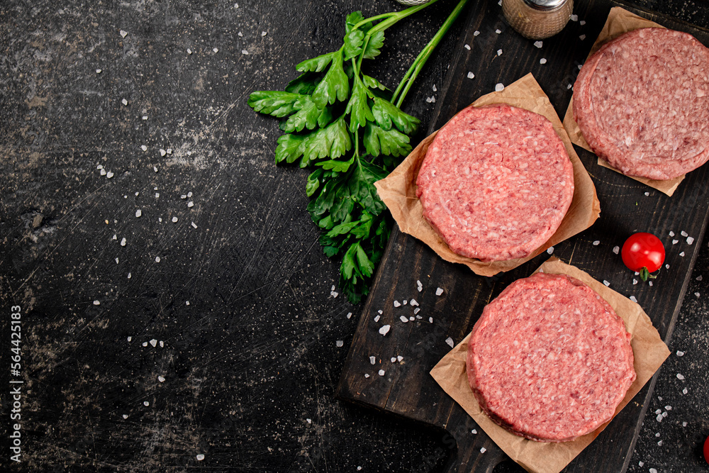 Raw burger on a cutting board. 