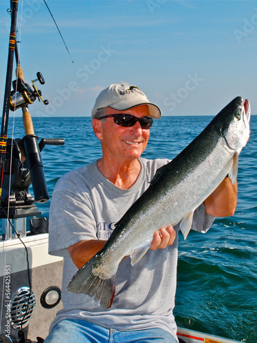 An angler with a steelhead trout