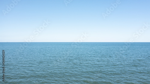 Horizon line, blue sky and blue sea. Drone view