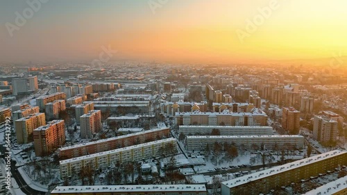 Aerial view of residential district at sunset in Krakow, Poland. Sleeping area, streets are covered with snow during winter.  photo